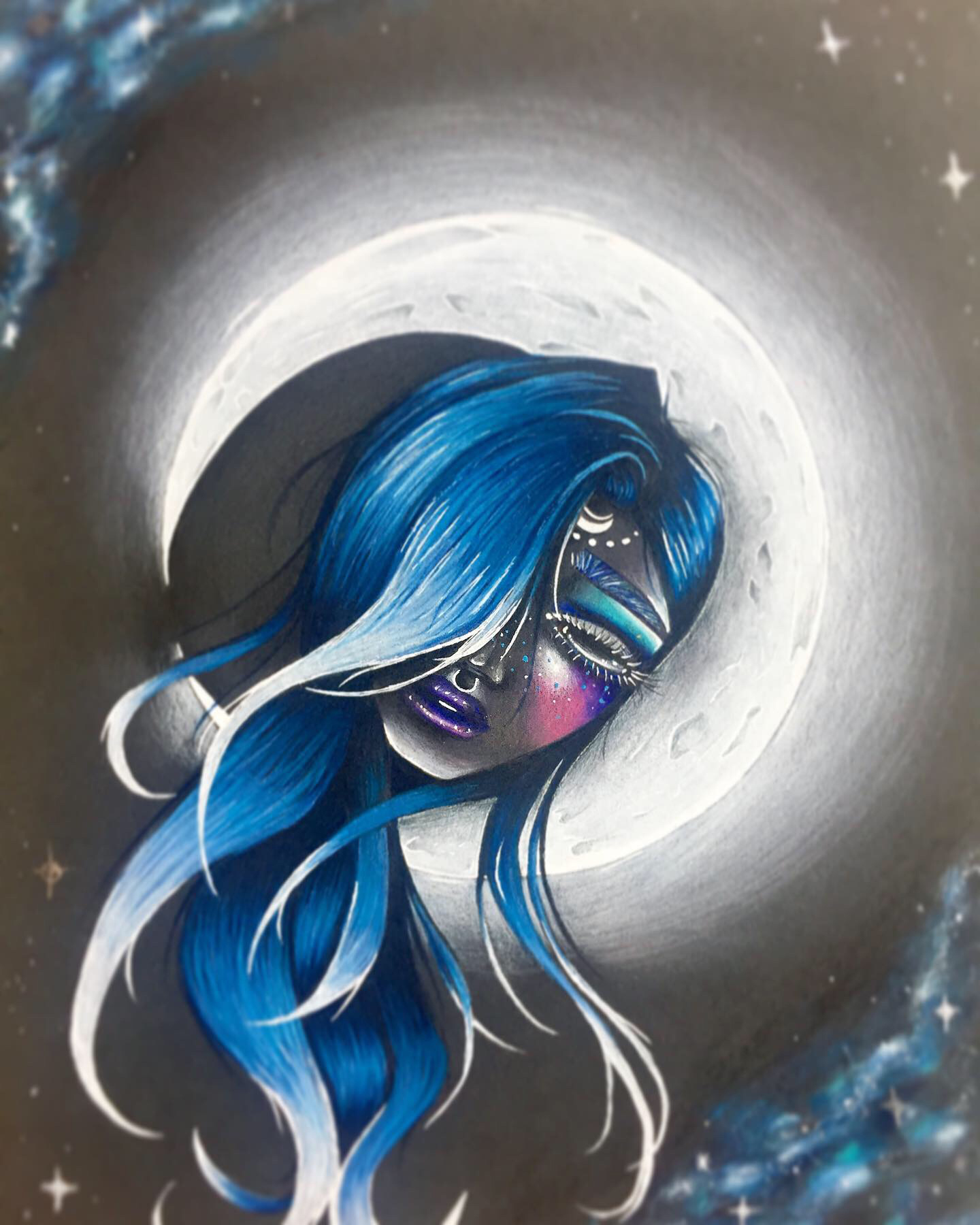 A drawing depicts a woman's disembodied head in front of a white full moon against a black sky. The woman's head is tilted approximately forty-five degrees clockwise and casts a shadow on the left side of the moon. Her face is predominantly dark gray. She is wearing a septum ring and has long, blue and white hair and purple lips. There is an arc of white dots on her forehead. Smaller, blue dots fleck her left cheek, which is colored pink and purple. The right side of her face is obscured by her hair. There is a blue and white galaxy-like pattern in the top-left and bottom-right corners of the image, and a few white stars in the other corners of the image.